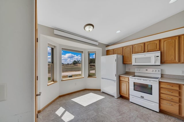 kitchen with light countertops, vaulted ceiling, white appliances, baseboards, and brown cabinetry