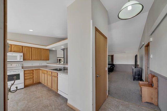 kitchen featuring recessed lighting, light countertops, a wood stove, a sink, and white appliances