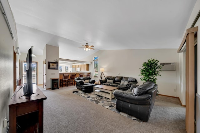 living area featuring an AC wall unit, vaulted ceiling, a ceiling fan, carpet floors, and baseboards