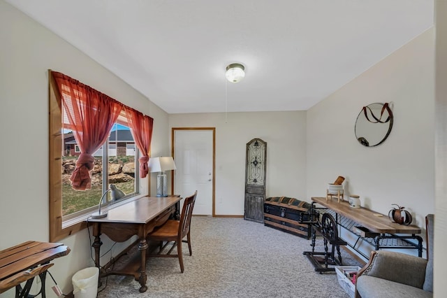 home office featuring baseboards and light carpet