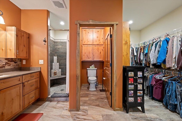 20097 Higgins Gulch Rd, Spearfish, SD 57783 - bathroom with visible vents, a shower stall, vanity, toilet, and a spacious closet