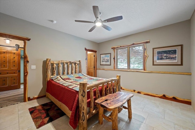 20097 Higgins Gulch Rd, Spearfish, SD 57783 - tiled bedroom with baseboards, a ceiling fan, and a textured ceiling
