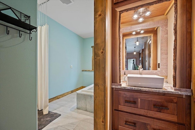 20097 Higgins Gulch Rd, Spearfish, SD 57783 - bathroom with vanity, baseboards, and a bathing tub