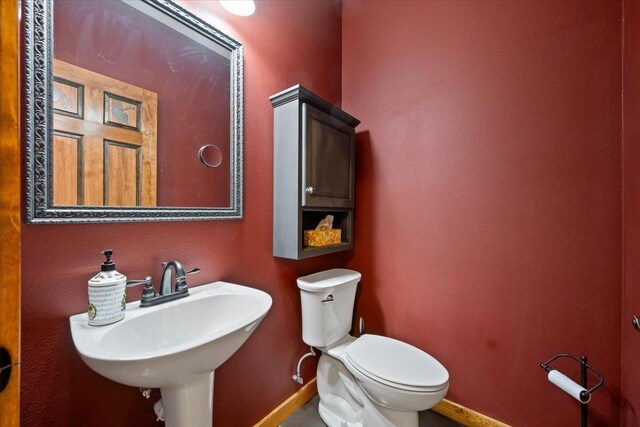 20097 Higgins Gulch Rd, Spearfish, SD 57783 - half bath featuring toilet, baseboards, and a sink