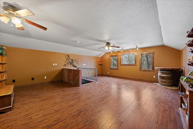 20097 Higgins Gulch Rd, Spearfish, SD 57783 - bonus room featuring a ceiling fan, a textured ceiling, vaulted ceiling, and wood finished floors