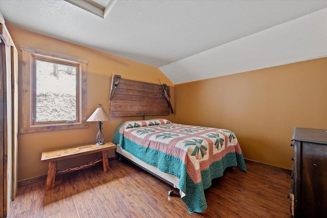 20097 Higgins Gulch Rd, Spearfish, SD 57783 - bedroom featuring a textured ceiling, baseboards, vaulted ceiling, and wood finished floors