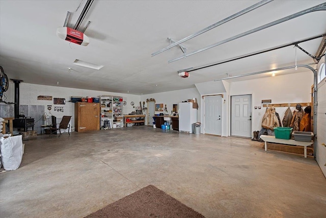 20097 Higgins Gulch Rd, Spearfish, SD 57783 - garage featuring a garage door opener and a wood stove