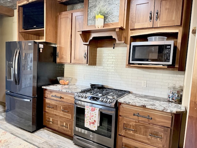 20097 Higgins Gulch Rd, Spearfish, SD 57783 - kitchen featuring backsplash, open shelves, light wood-type flooring, light stone counters, and stainless steel appliances