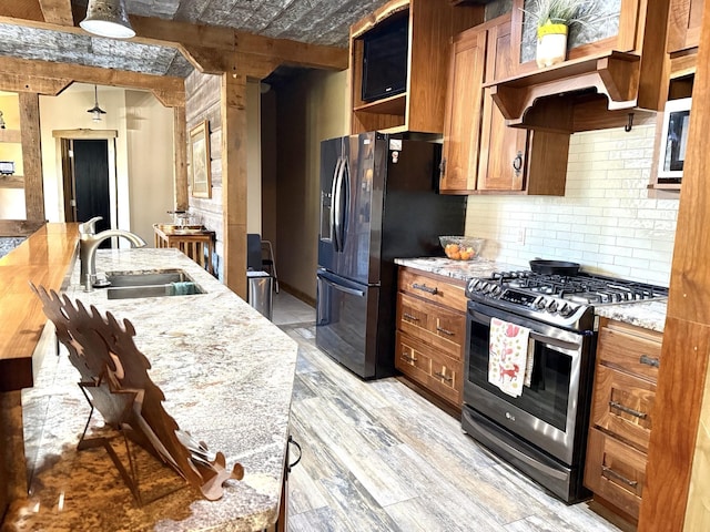 20097 Higgins Gulch Rd, Spearfish, SD 57783 - kitchen with backsplash, appliances with stainless steel finishes, open shelves, light wood-type flooring, and a sink