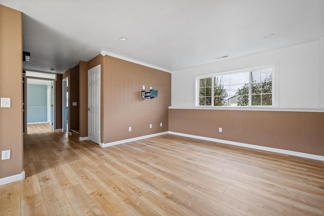 empty room featuring light wood-style floors and baseboards