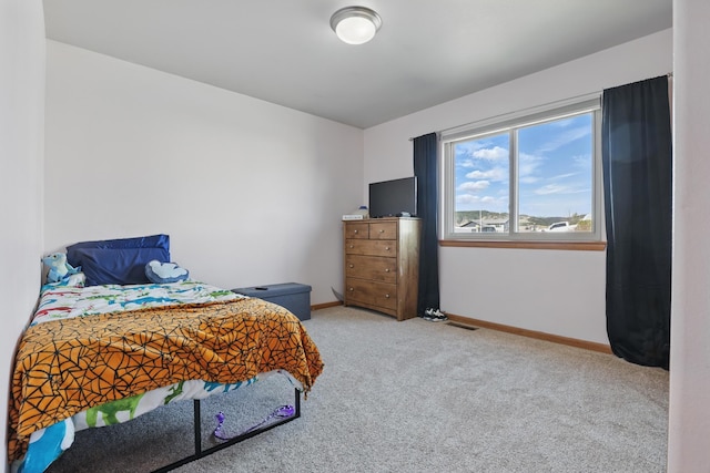 bedroom featuring carpet flooring and baseboards