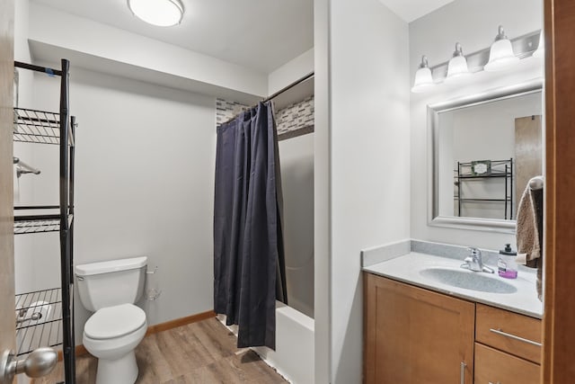 bathroom featuring shower / bath combo, wood finished floors, toilet, and vanity