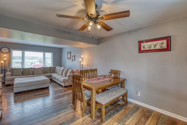 dining area with wood finished floors, a ceiling fan, and baseboards