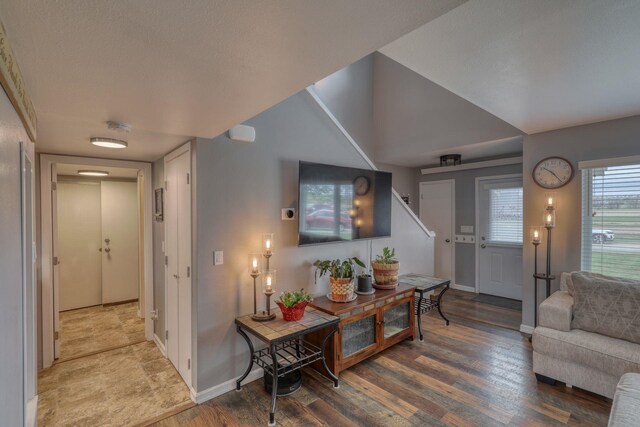 interior space with wood finished floors, stairs, and baseboards