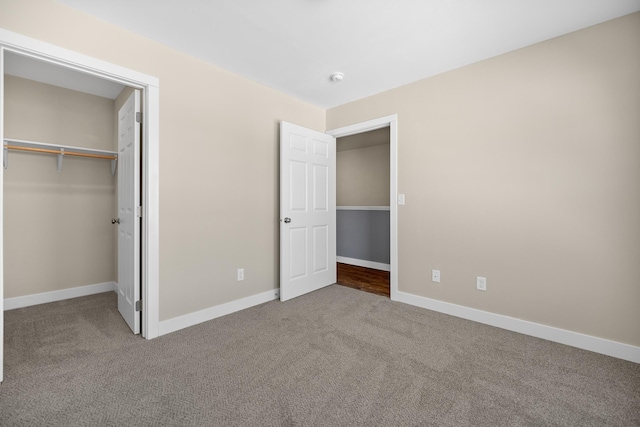 unfurnished bedroom with baseboards and carpet flooring