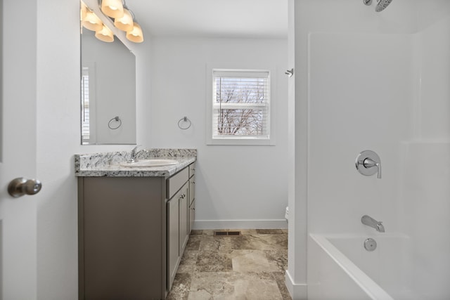 bathroom featuring bathtub / shower combination, baseboards, visible vents, stone finish flooring, and vanity