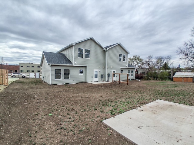 rear view of house featuring fence and a patio
