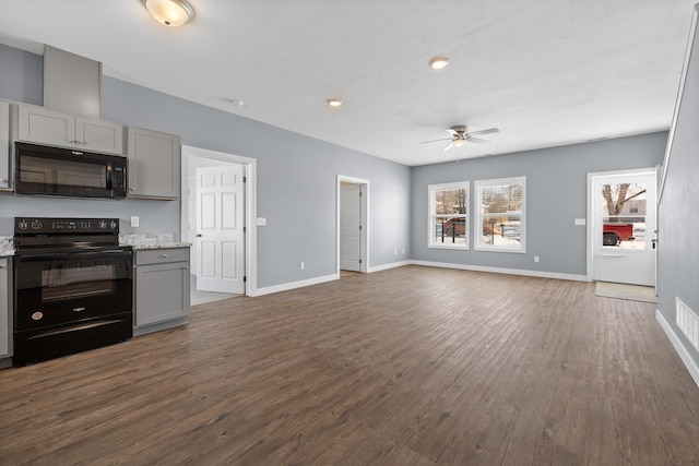 unfurnished living room featuring baseboards, a ceiling fan, dark wood-style floors, and recessed lighting