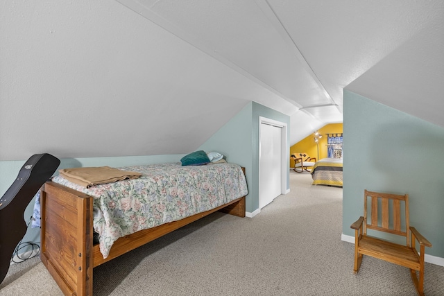 bedroom featuring vaulted ceiling, baseboards, and carpet