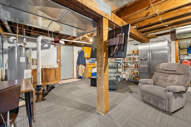 unfinished below grade area with carpet floors, electric water heater, and stainless steel fridge