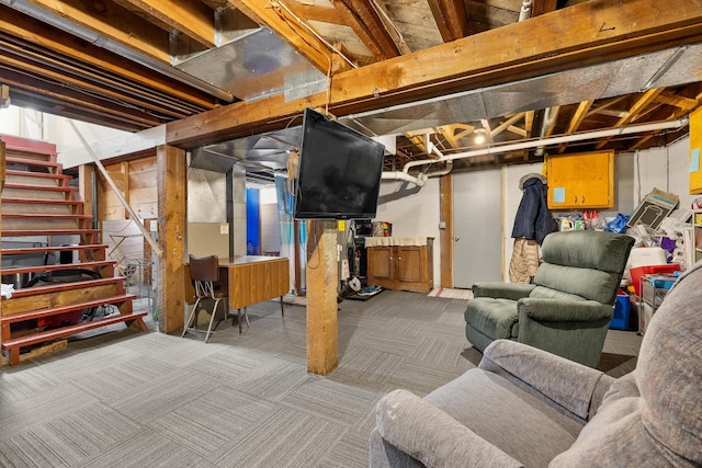 unfinished below grade area featuring carpet floors and stairs