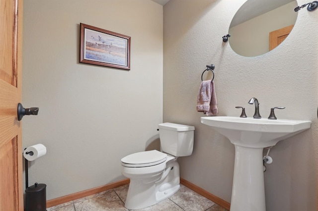 12388 Little Tiger Ln, Hill City, SD 57745 - half bath with tile patterned floors, baseboards, and toilet