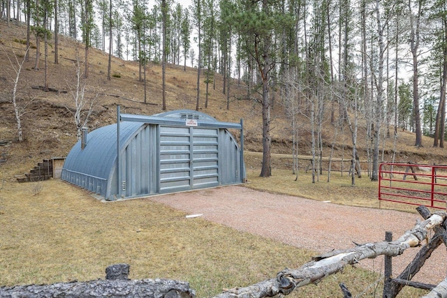 12388 Little Tiger Ln, Hill City, SD 57745 - view of outbuilding featuring an outdoor structure, dirt driveway, and fence