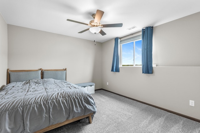 carpeted bedroom featuring baseboards, a ceiling fan, and visible vents