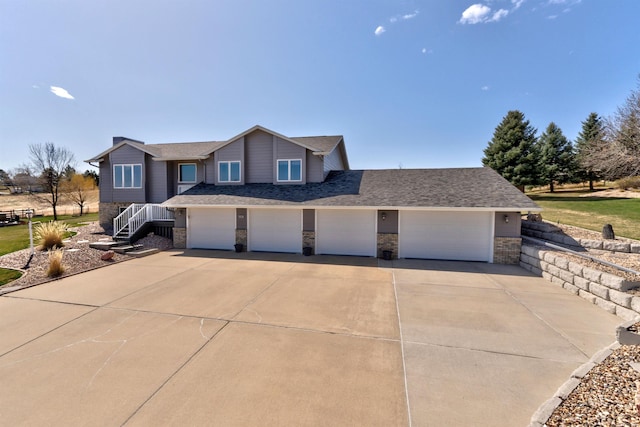 5341 Scrub Oak Cir, Rapid City, SD 57702 - traditional-style house with roof with shingles, stone siding, and concrete driveway