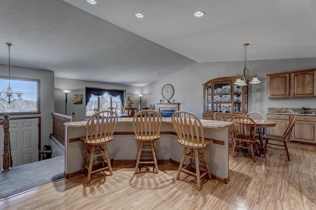 5341 Scrub Oak Cir, Rapid City, SD 57702 - interior space with a breakfast bar, light wood-style floors, and a textured ceiling