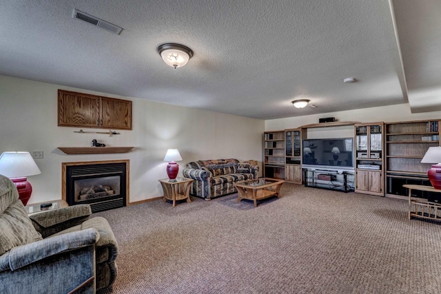 5341 Scrub Oak Cir, Rapid City, SD 57702 - carpeted living area featuring a glass covered fireplace, visible vents, and a textured ceiling