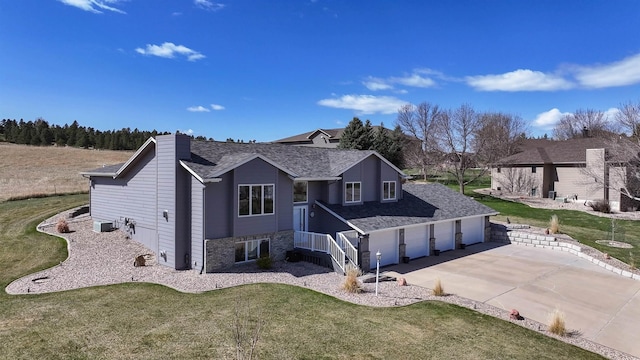 5341 Scrub Oak Cir, Rapid City, SD 57702 - view of front facade with concrete driveway, roof with shingles, and a front yard