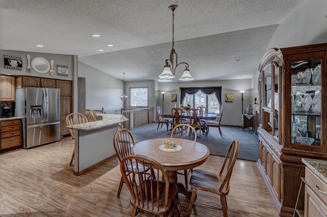 5341 Scrub Oak Cir, Rapid City, SD 57702 - dining area featuring lofted ceiling, a textured ceiling, and light wood finished floors
