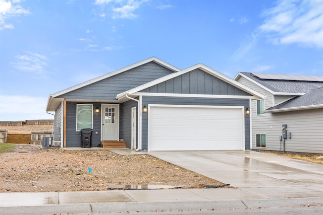 130 Diamond Ridge Blvd, Rapid City, SD 57703 - view of front of property featuring driveway, central AC, entry steps, and a garage