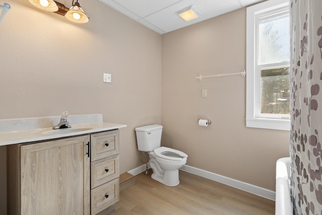 full bathroom featuring toilet, wood finished floors, vanity, and baseboards