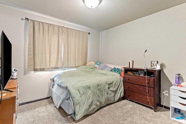 bedroom featuring baseboards and carpet floors