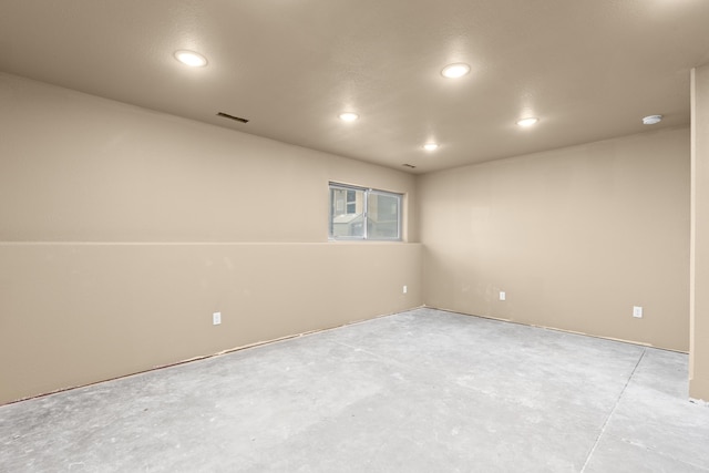 spare room with recessed lighting, visible vents, and unfinished concrete flooring