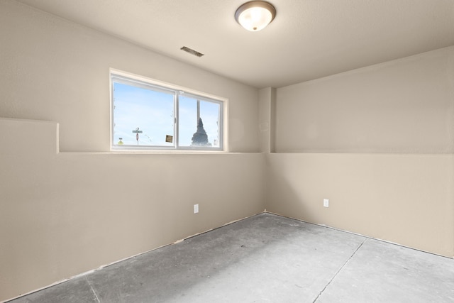 unfurnished room with visible vents and unfinished concrete floors