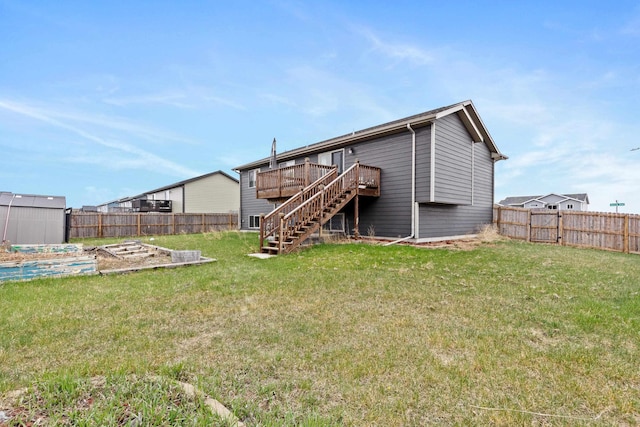 back of house with a garden, a wooden deck, stairway, a yard, and a fenced backyard