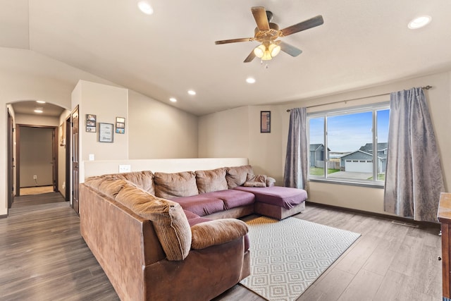 living area featuring lofted ceiling, ceiling fan, arched walkways, recessed lighting, and wood finished floors