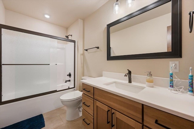 full bathroom featuring tile patterned floors, toilet, combined bath / shower with glass door, and vanity
