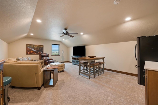 living room with a ceiling fan, light carpet, a textured ceiling, and vaulted ceiling