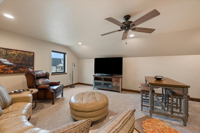 living room with light colored carpet, vaulted ceiling, and baseboards