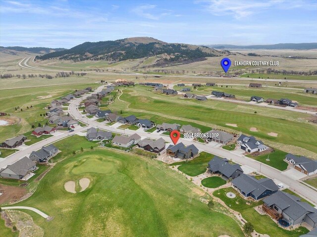 birds eye view of property with a mountain view and golf course view