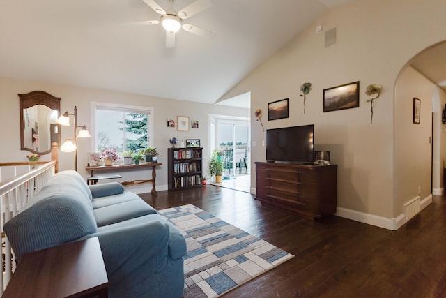 living room with arched walkways, wood finished floors, ceiling fan, baseboards, and visible vents