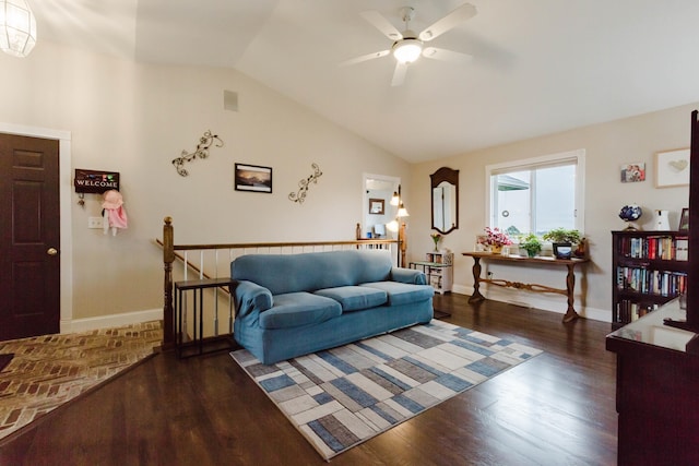 living room featuring ceiling fan, vaulted ceiling, wood finished floors, and baseboards