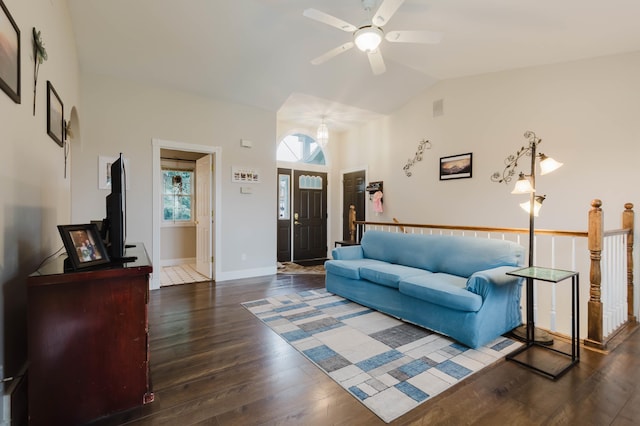 living area with baseboards, wood finished floors, a ceiling fan, and lofted ceiling
