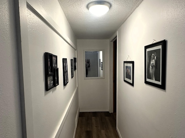 306 10th Ave, Edgemont, SD 57735 - hall with dark wood-style floors, a textured ceiling, and baseboards