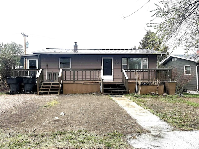 306 10th Ave, Edgemont, SD 57735 - manufactured / mobile home with a standing seam roof, metal roof, a wooden deck, and stairway