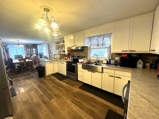 306 10th Ave, Edgemont, SD 57735 - kitchen featuring electric stove, a chandelier, under cabinet range hood, dark wood-style floors, and white cabinetry